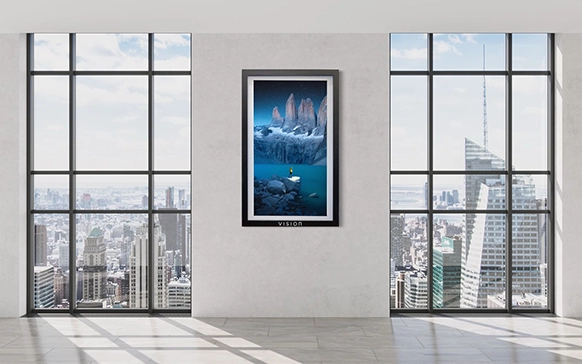 Framed digital artwork of icy mountains in modern office with panoramic city view
